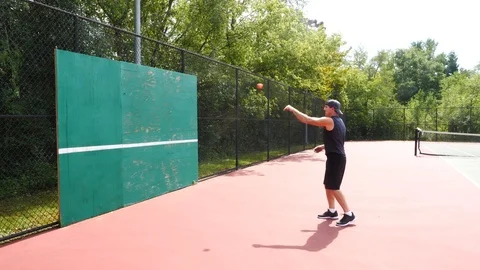 Athletic man working out training exercising throwing ball, 4k, 60fps. Stock Footage 116146971