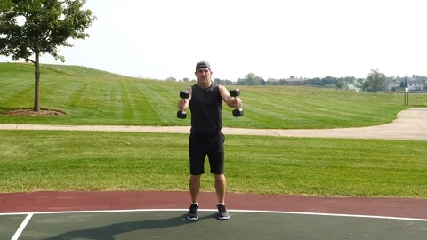 Athletic man working out training exercising front to side raises, 4k, 60fps. Stock Footage 116147986