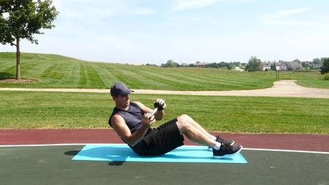 Athletic man working out training exercising Russian twists, 4k, 60fps. Stock Footage 116148522