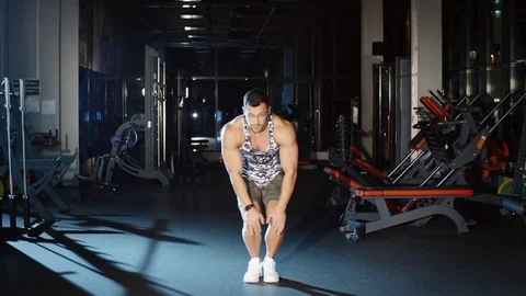 Athletic man workout and trains legs joins and knees circle exercises Stock Footage 80470331