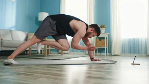 Athletic Man Is Workouting Using Gadget Stock-Footage 135322851