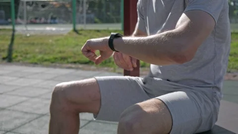 Athletic mans hands with smartwatch power on touching and scrolling. 库存影片 94916880