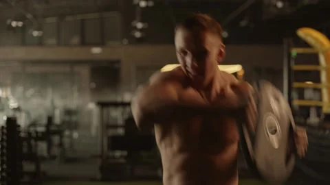 Athletic men doing exercises in the gym. a naked muscular torso Plate press Stock Footage 269133708