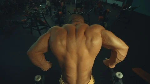 Athletic men pumping up muscles push-ups on uneven bars Video stock 118776103