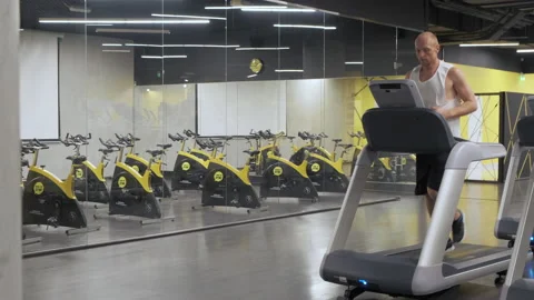 Athletic men running exercise in gym on treadmill Stock Footage 141988316