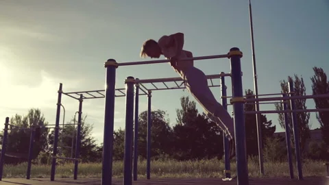 Athletic men training on parallel crossbars Stock Footage 91164120