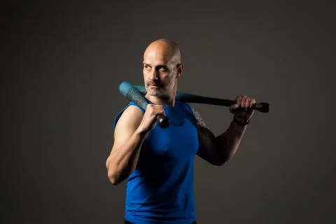 Athletic, middle aged man training with clubbells, studio background Stock Photos