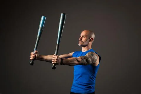 Athletic, middle aged man training with clubbells, studio background Stock Photos