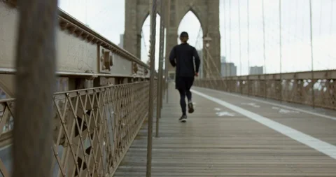 Athletic Runner Running On Iconic Beautiful Brooklyn Bridge  Stock Footage 112759041