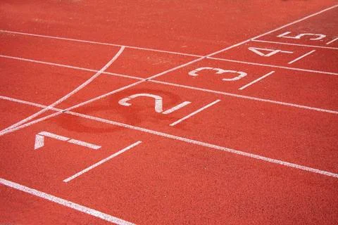 Athletic running track in a stadium with start point positions two to five. Stock Photos