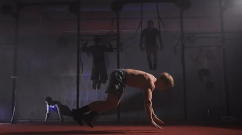 Athletic shirtless man doing backflip burpee at the gym Stock Footage 68777477