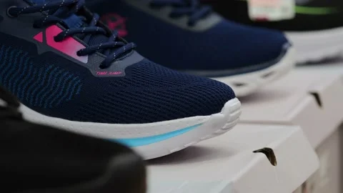 Athletic shoes on the shelf in the store. Video stock 229295118