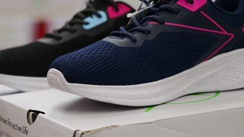 Athletic shoes on the shelf in the store. Video stock 229295356