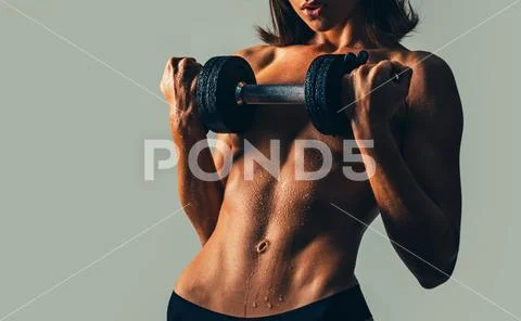 Athletic sportswoman working in a gym. Sports, athletics and fitness concept Stock Photos