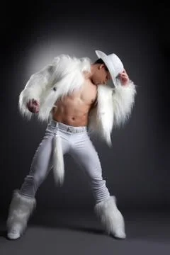 Athletic striptease dancer in white cowboy costume Stock Photos