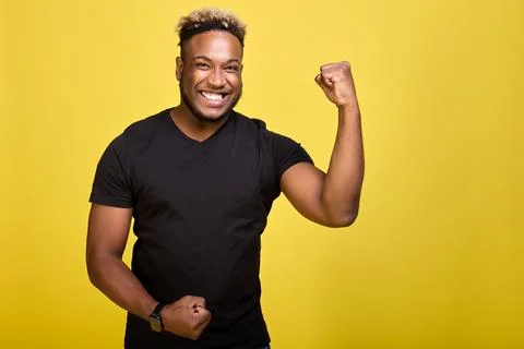 Athletic strong guy brags about his muscles in front of camera Stock Photos