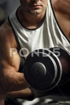 Athletic strong sportsman having a weightlifting training Stock Photos