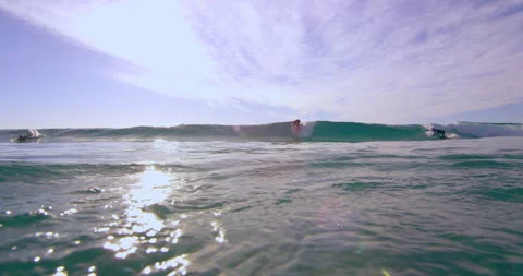 Athletic surfers on surfboards riding a large ocean wave in Australian beach wit Stock Footage 199459014