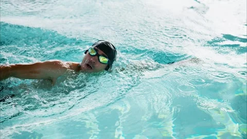 An Athletic Swimmer Practicing in a Pool, Mastering Freestyle Stroke Techniques Stock Footage 317077053