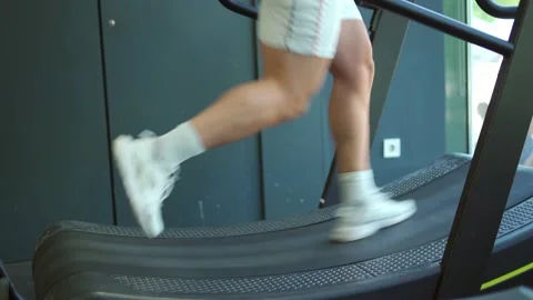 Athletic unrecognizable man running on the treadmill in the gym. Stock Footage 197571846