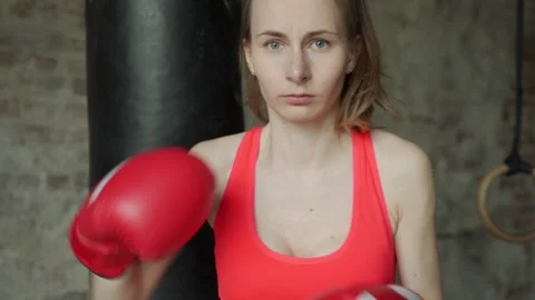 An athletic woman in boxers gloves posing for the camera Stock