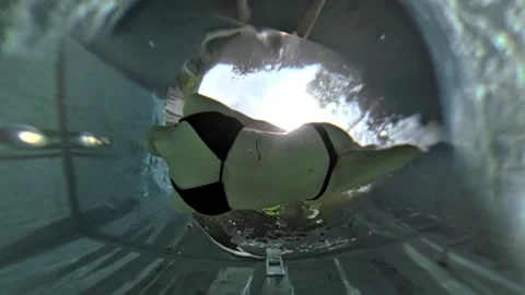 Athletic woman diving in a pool, creating a splash and bubbles Stock Footage 301500326