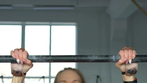 Athletic woman does pull ups in the gym. Stock Footage 106364320