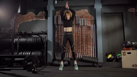 Athletic woman doing burbee exercise in gym Stock Footage 124864230