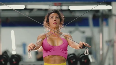 Athletic woman doing cable crossover exercise Stock Footage 332413472