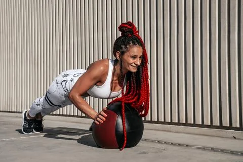 Athletic woman doing exercise push ups with med ball. Strength and motivati.. Stock Photos
