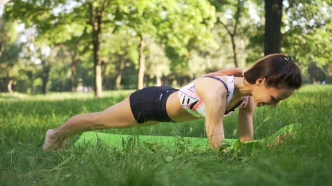 Athletic woman doing plank exercise outdoor.  Stock-Footage 87837726