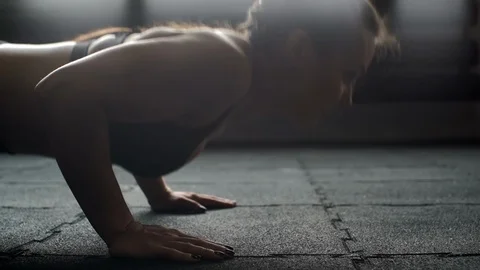 Athletic woman doing push-ups close up on her face in slow motion in the gym Video stock 106815566