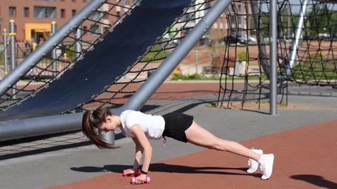 Athletic woman doing a push ups on the playground. Stock Footage 154846060