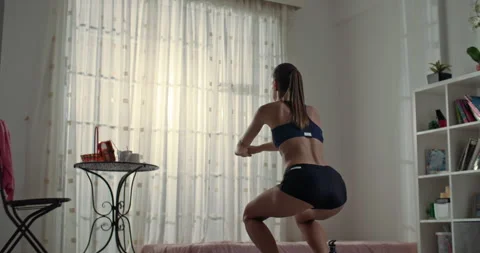 Athletic woman doing squat exercise from fitness at home Stock Footage 247247976