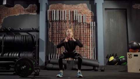 Athletic woman doing squats exercise in gym Stock Footage 124862904