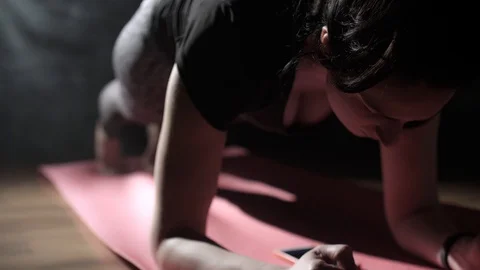 Athletic woman exercising doing exercise on black background Stock Footage 128604900