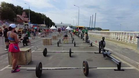 Athletic woman getting ready to do barbell squats, many barbells on the court Video stock 205065072