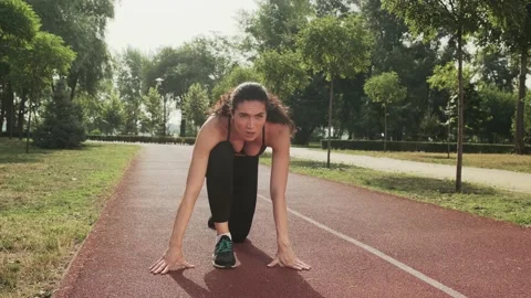 Athletic woman getting ready to start outdoor. Female runner prepare for jogging Stock Footage 157785385