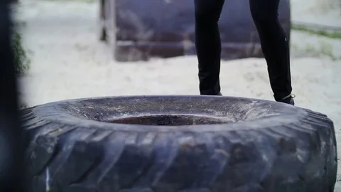 Athletic woman in a grey top and black leggings performs strength exercises Stock Footage
