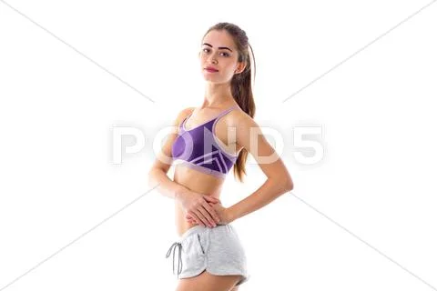 Athletic woman holding hands on her side Stock Photos