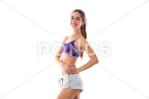 Athletic woman holding hands on her side Stock Photos