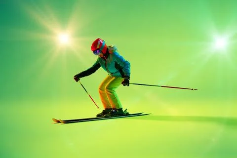 Athletic woman, kier bends into sharp turn against glowing green backdrop Stock Photos
