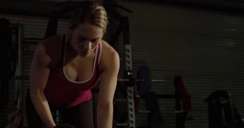 Athletic woman lifting dumbbell weights Video stock 83302953