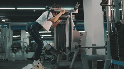Athletic woman performing hack squats at the gym Stock Footage 332483712