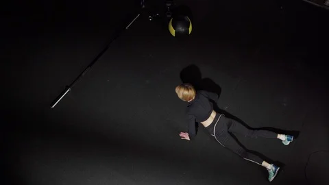 Athletic woman practicing burpee exercise in gym Stock Footage 124867232