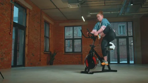 Athletic woman riding on spinning Stock Video Pond5