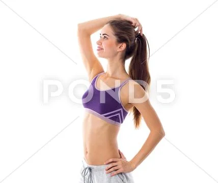 Athletic woman in sportswear standing sidewise Stock Photos