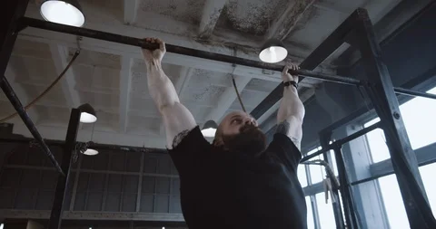 Athletic young Caucasian man doing pull-up exercises during functional workout Stock Footage 116806145