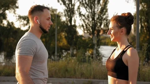 Athletic young couple cross their arms standing in the Park after a workout. Stock Footage 158557276