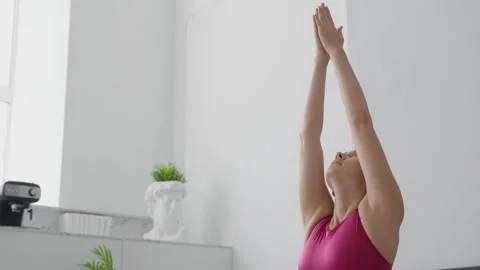 Athletic young female exercising, practising meditation in morning at home Stock Footage 248308616